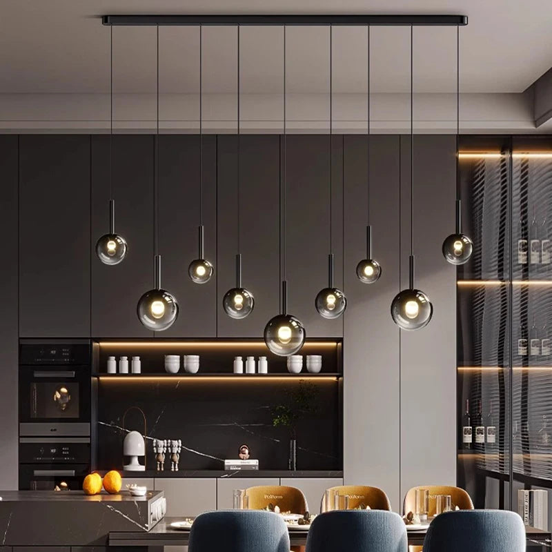 Modern kitchen with pendant lights and a dining area.