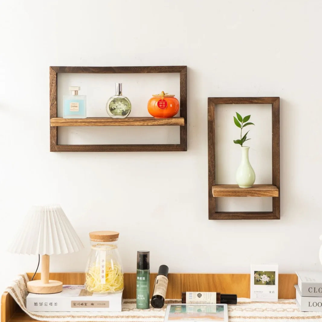 Wooden wall shelves with decorative items against a white wall.