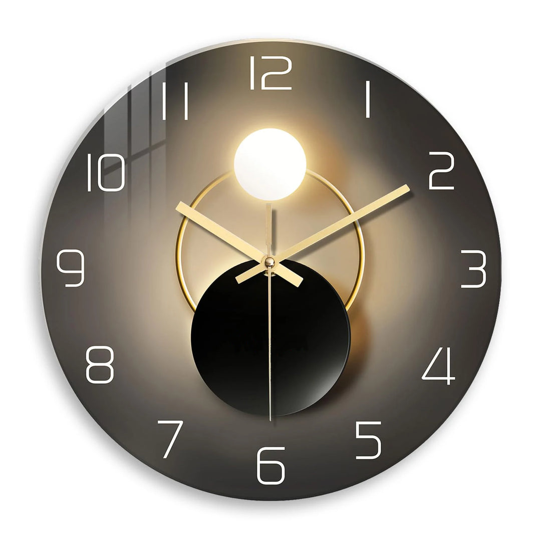 Modern wall clock with black and gold design on a white background