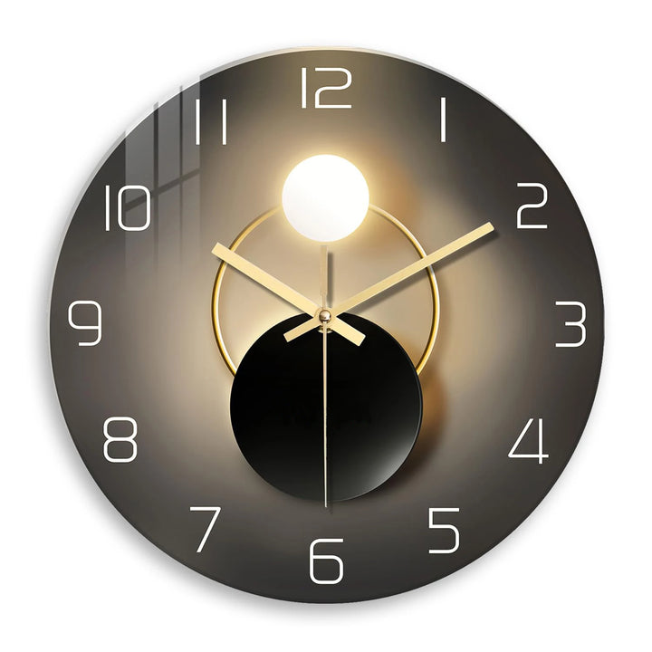 Modern wall clock with black and gold design on a white background