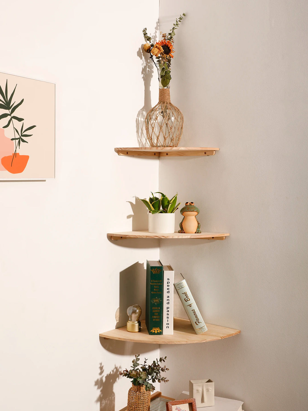 Three wooden shelves with decorative items against a light wall.